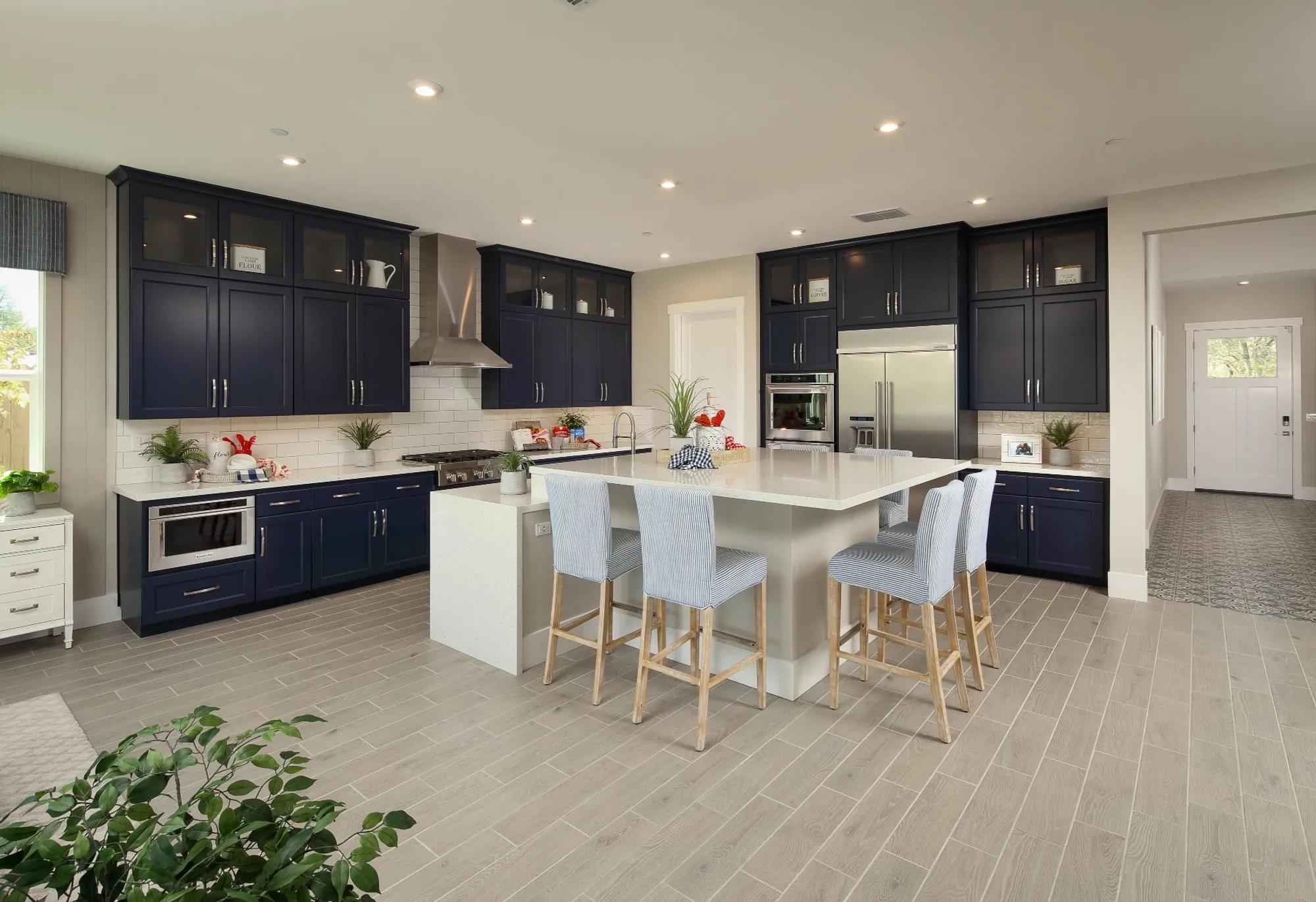 Contemporary kitchen with dark wood cabinets and marble countertops