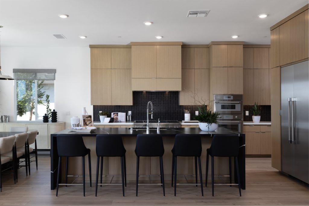 Modern white kitchen with large island and pendant lights