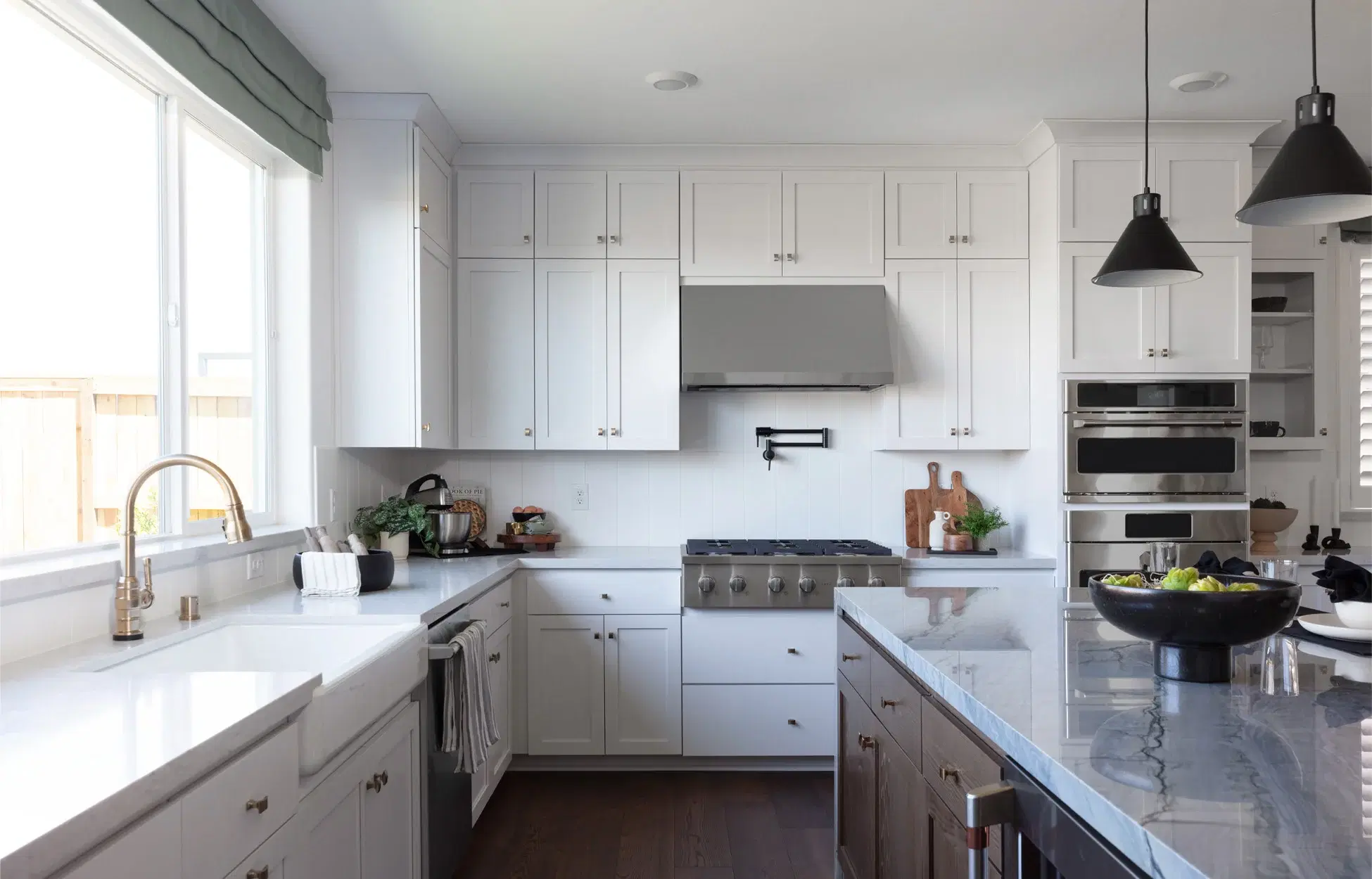 Modern white kitchen with large island and pendant lights