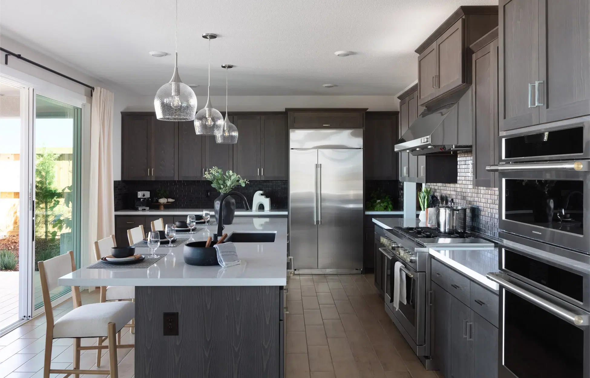 Contemporary kitchen with dark wood cabinets and marble countertops