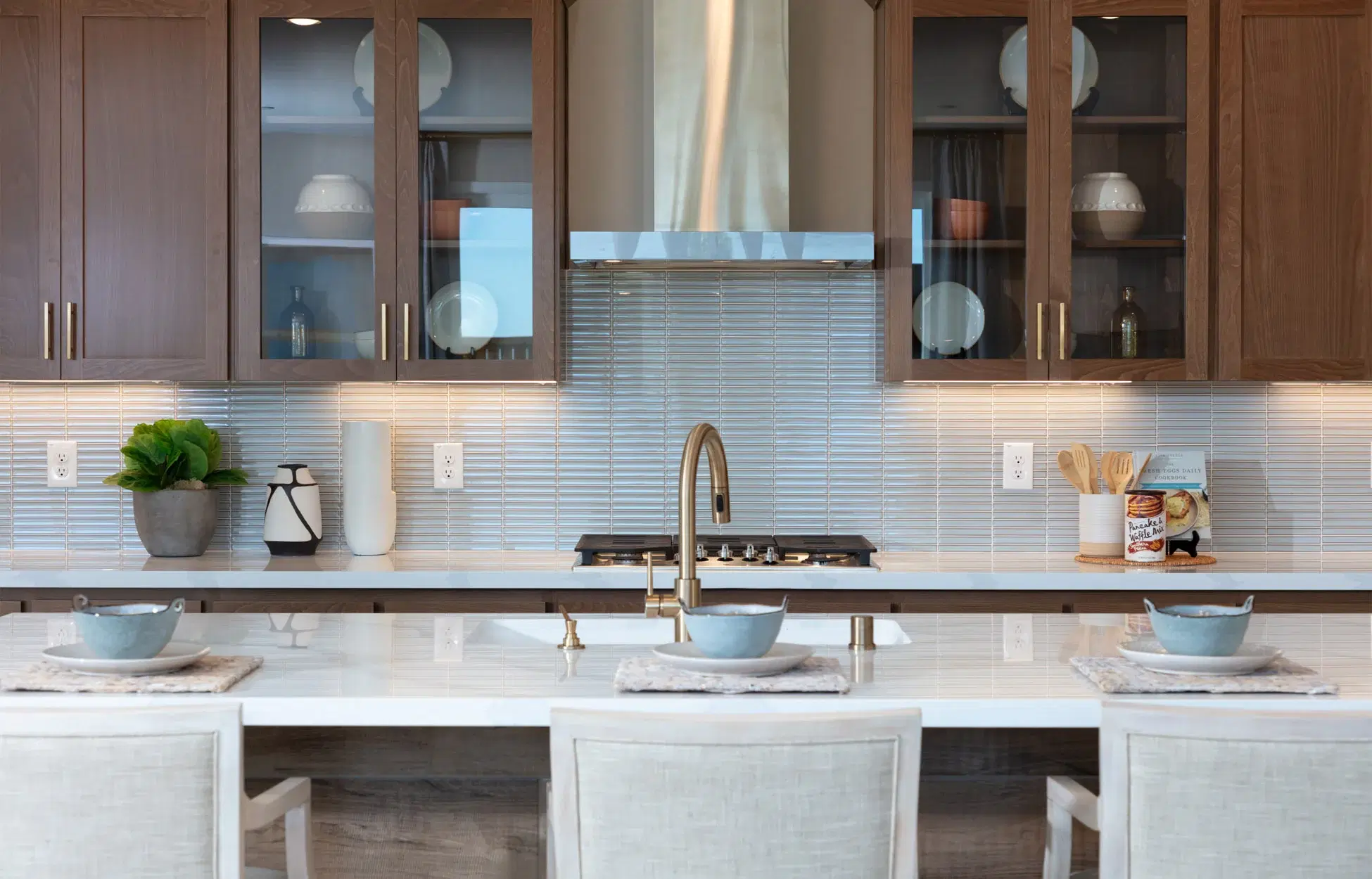 Contemporary kitchen with dark wood cabinets and marble countertops